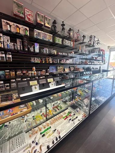 Glass pipes, hookahs and smoking accessories in the display cases at Smoke To Live Culebra Rd