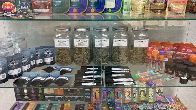 Hemp flower jars, Delta-8 edibles and Koi CBD products in the display case at Smoke To Live Nacogdoches